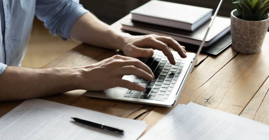 Man using laptop to study legal writing skill for the MBE