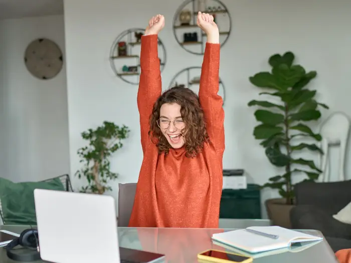 A female student looking at her successful BAR exam pass rates on the Themis+UWorld platform and celebrating the same.