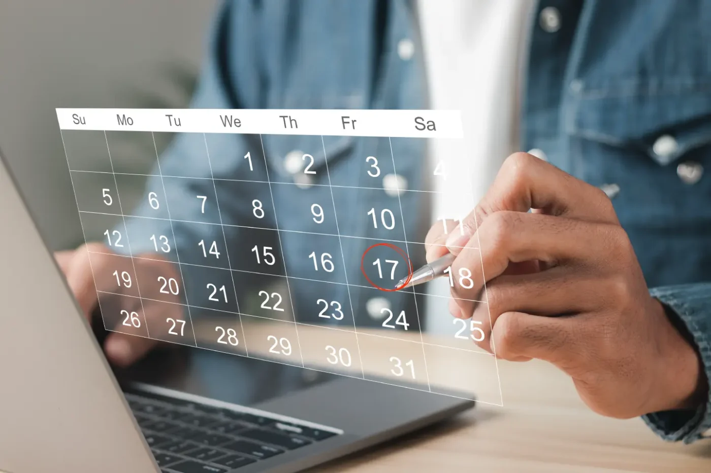 A law student marking bar exam dates on a 3D calendar projected from a laptop.