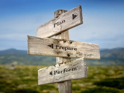 Plan prepare preform text quote on a wooden signpost outdoors in nature.