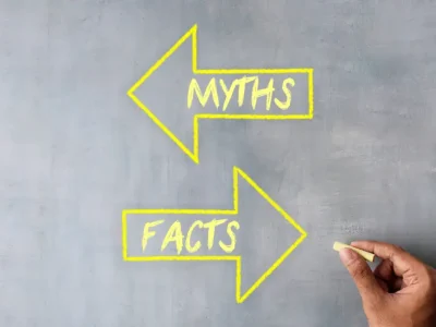 Chalkboard image of two arrows, one pointing left saying myths and one pointing right saying facts.