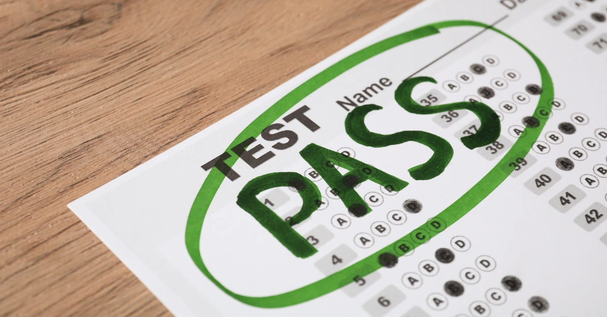 MBE multiple-choice test answer sheet with the word 'PASS' written in bold green letters and circled, indicating a successful test result.